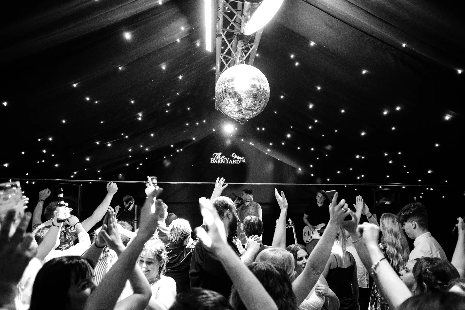 Guests celebrating on the dancefloor at The BarnYard